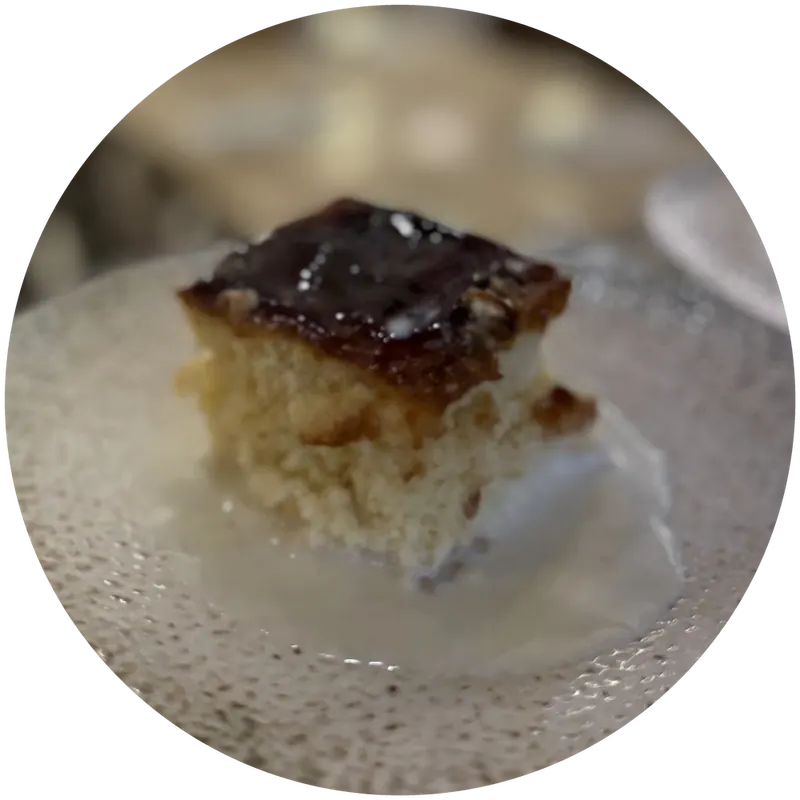 A square of trileçe with a caramel top on a textured glass plate