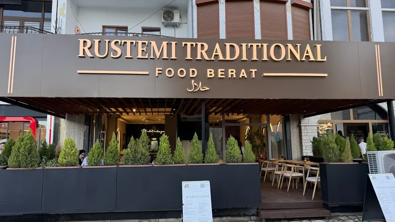 The front of Rustemi Traditional Food Berat, with the halal sign above the terrace